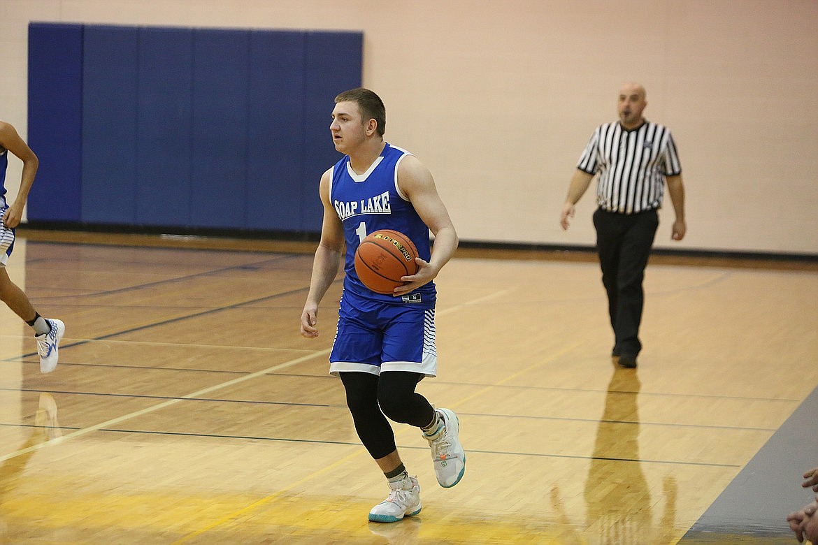 Soap Lake senior Pavlo Stoyan takes the ball up the floor against Wilson Creek.