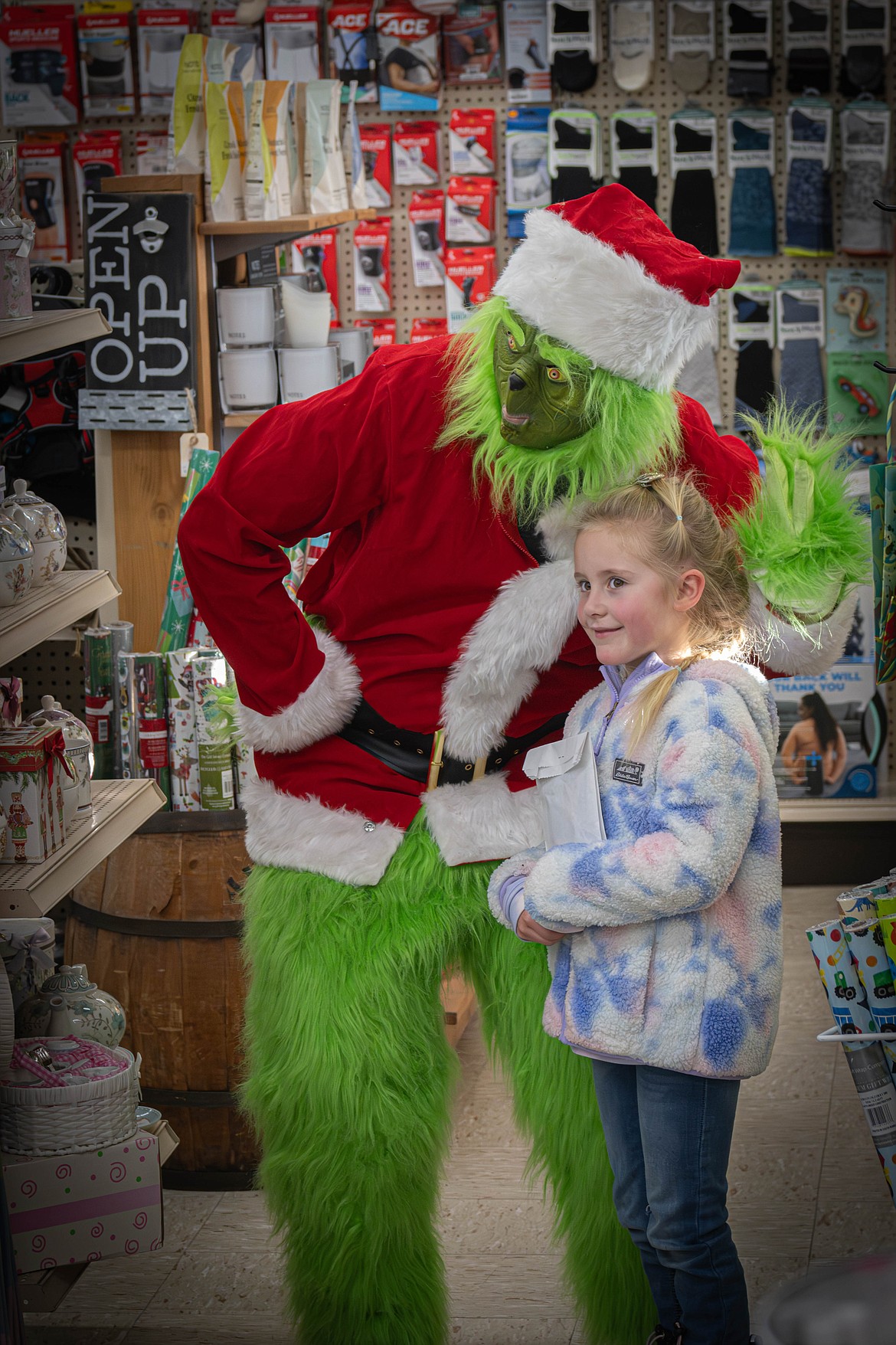 Adeline Huyghe, 6, with Mr. Grinch at the Plains Drug Store. (Tracy Scott/Valley Press)