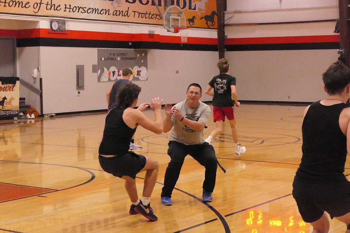 Plains head coach Tyrel Allen works on defensive positioning with one of his players during preseason practice last week in Plains. (Chuck Bandel/VP-MI)