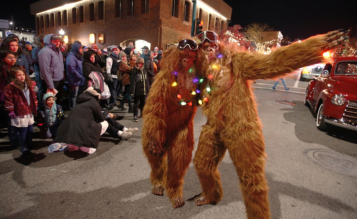 A pair sasquatches have fun in the parade.