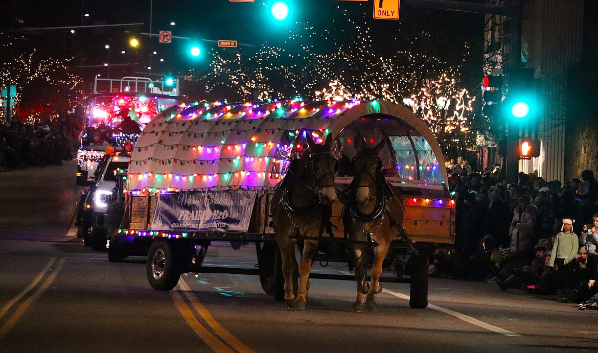An equestrian-powered wagon with Prairie Potable Water Services makes a turn in the parade.