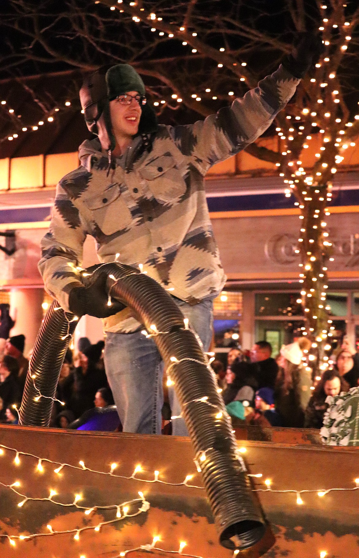 Chase Goeltzenleuchter dressed as cousin Eddie from "Christmas Vacation" waves to the crowd during Friday's parade.