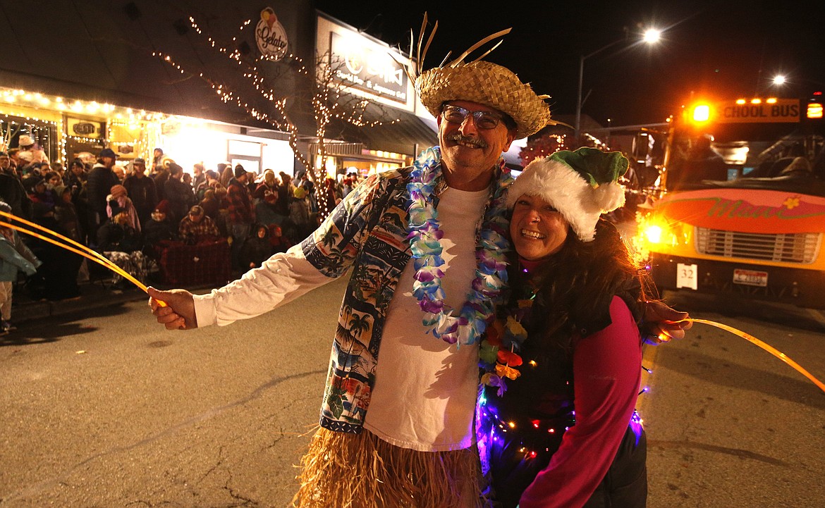 Doug Giovanelli and Chelsea Holmes spread Christmas cheer in downtown parade on Friday.
