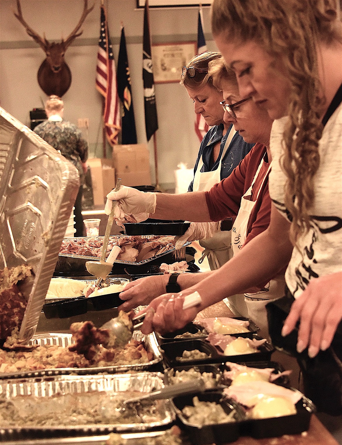 Volunteer servers at the Polson Community Thanksgiving Dinner dish up a delicious feast for community members. (Berl tiskus/Leader)