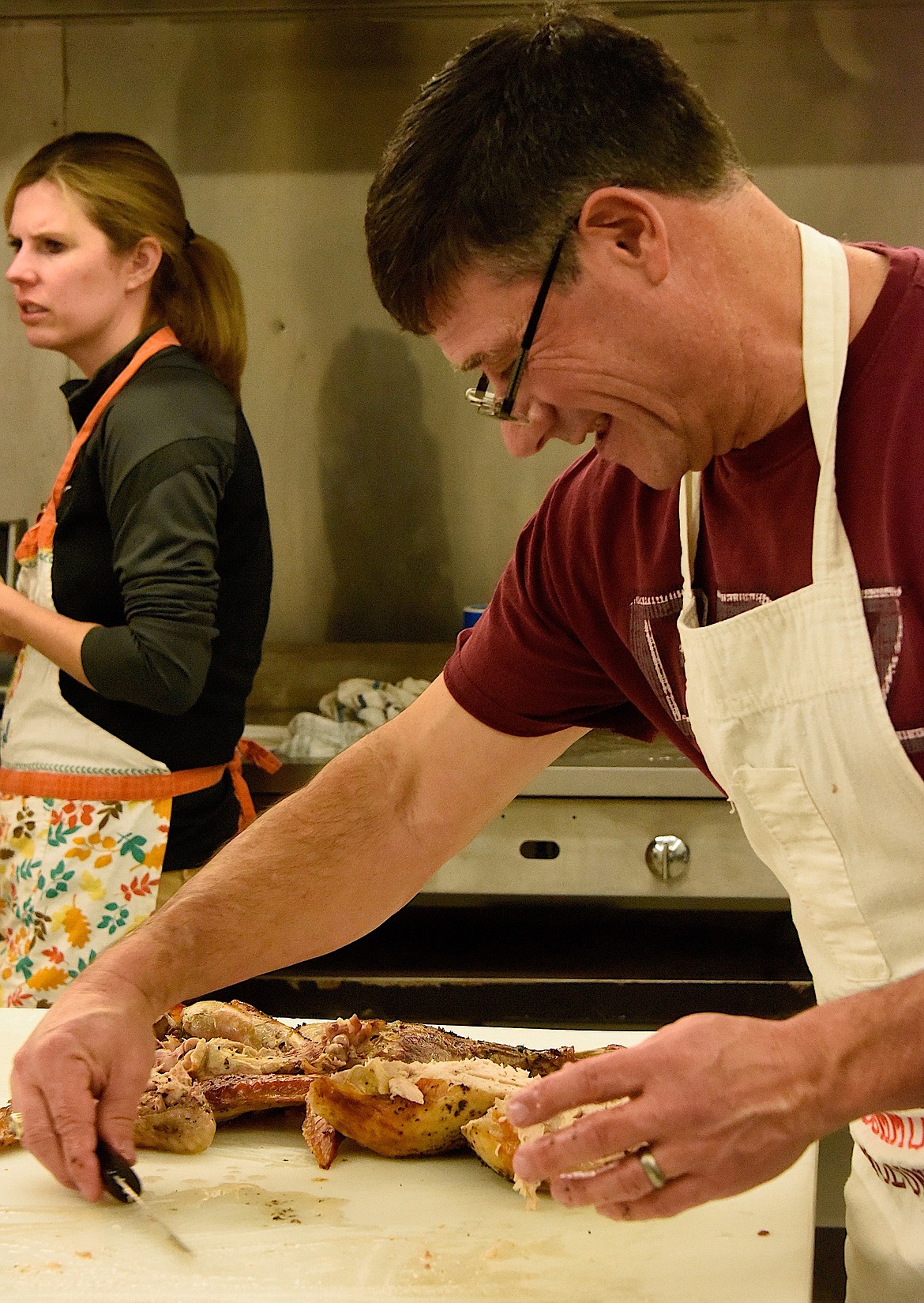 Thom Chisholm debones turkey for Thanksgiving dinner plates at the Ronan community Thanksgiving Dinner. (Berl Tiskus/Leader)