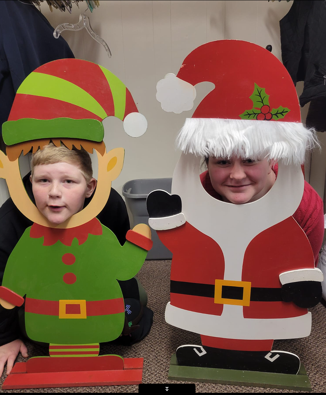 Kids pose in Santa and elf cutouts at the 2022 Pinehurst Christmas Festival.