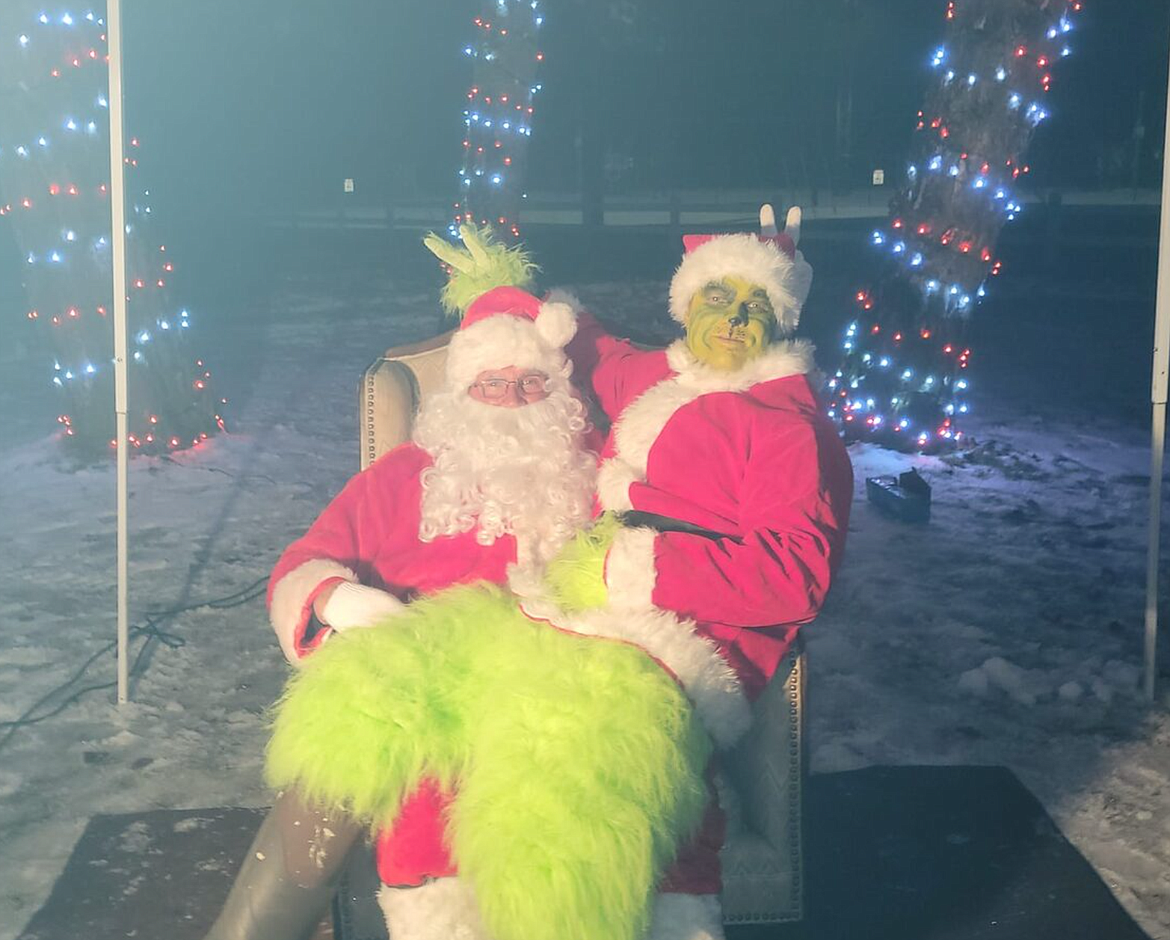 Santa asks the Grinch what he wants for Christmas during the 2022 Pinehurst Christmas Festival.