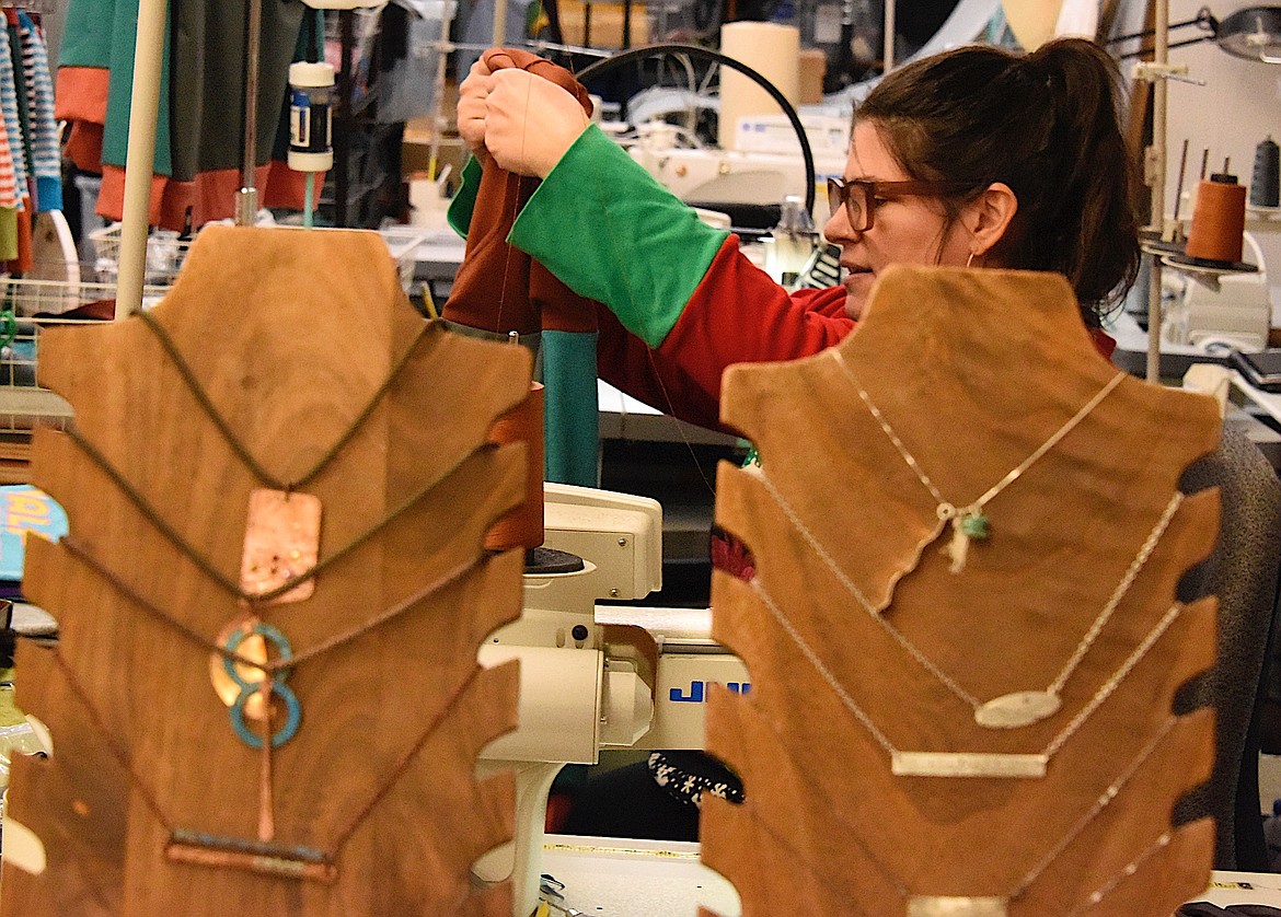 Carol Lynn Lapotka holds up a project to show customers in her business, handMADE Montana, during Shop small Business Saturday. (Berl Tiskus/Leader)