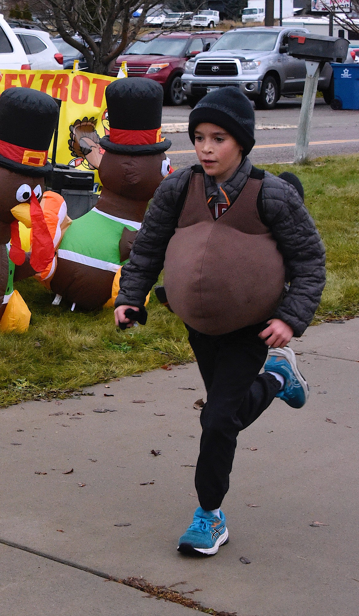 Runner Trevor Montgomery in his turkey costume finished strong in the Turkey Trot on Thanksgiving morning. (Berl Tiskus/Leader)