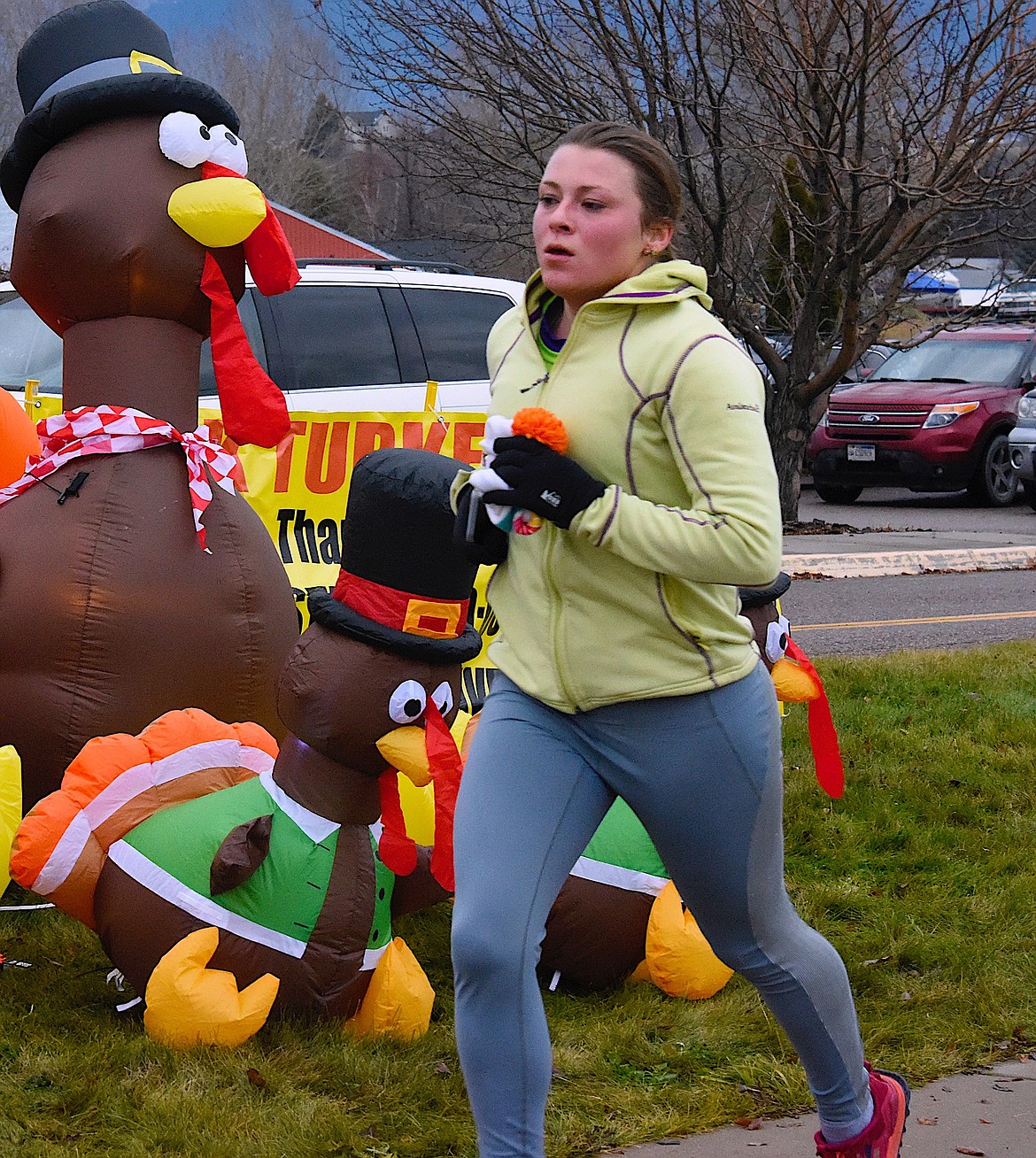 Runner Claire Scam finishes strong at the Turkey Trot on Thanksgiving morning. (Berl Tiskus/Leader)