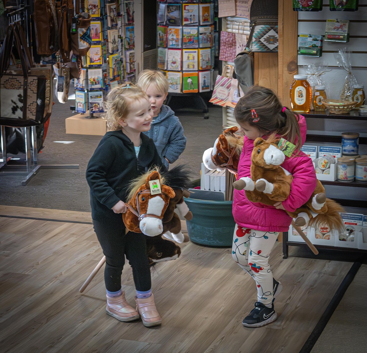 Children find toy horses at 406 Outlet Store during the Plains Small Business events. (Tracy Scott/Valley Press)