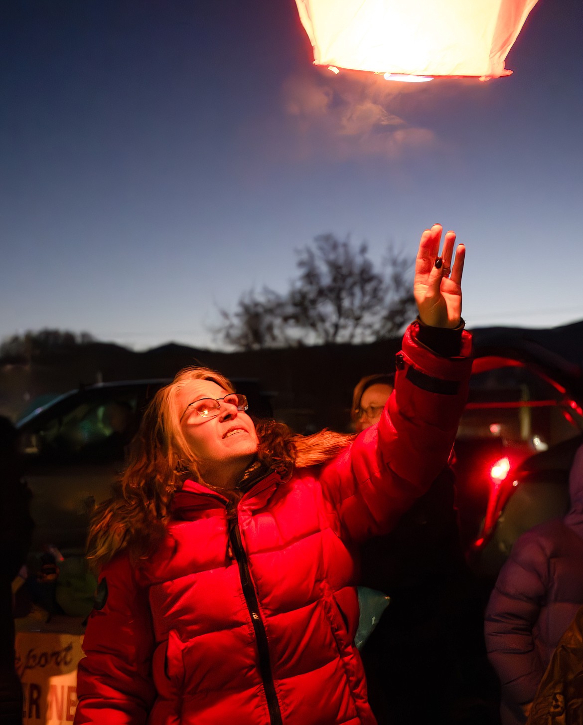 Shelley Bertrand, president of the Cancer Network of Sanders County, launches a lantern. (Tracy Scott/Valley Press)