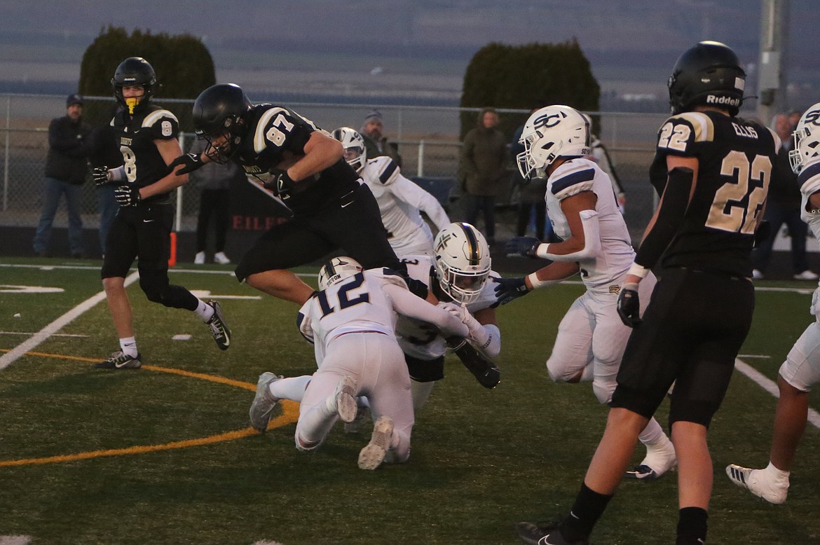 Royal senior Bennett Brown (87) fights for extra yards in the first quarter against Seton Catholic.