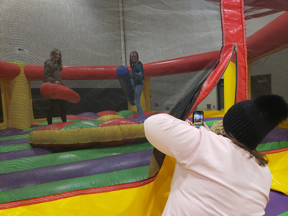 Charisa Childress takes photos of her students Polina Afichuk and Aleigha Persyn before they fight to the finish in a Timberlake Junior School jousting match for the school Renaissance faire.