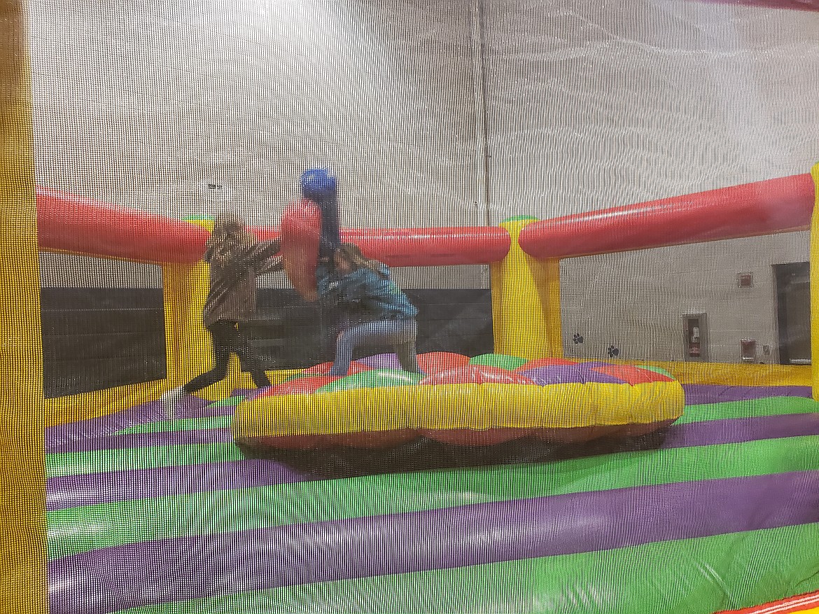 From left, eight graders Polina Afichuk and Aleigha Persyn work out their differences in a jousting match at the Timberlake Junior School gym.