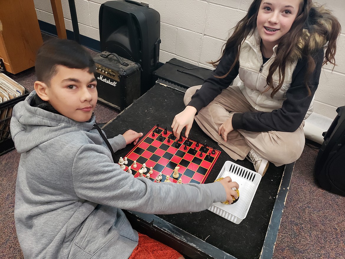 From left, Ryker Montes and Khloe Perkle play chess during the Timberlake Junior School renaissance faire Wednesday.