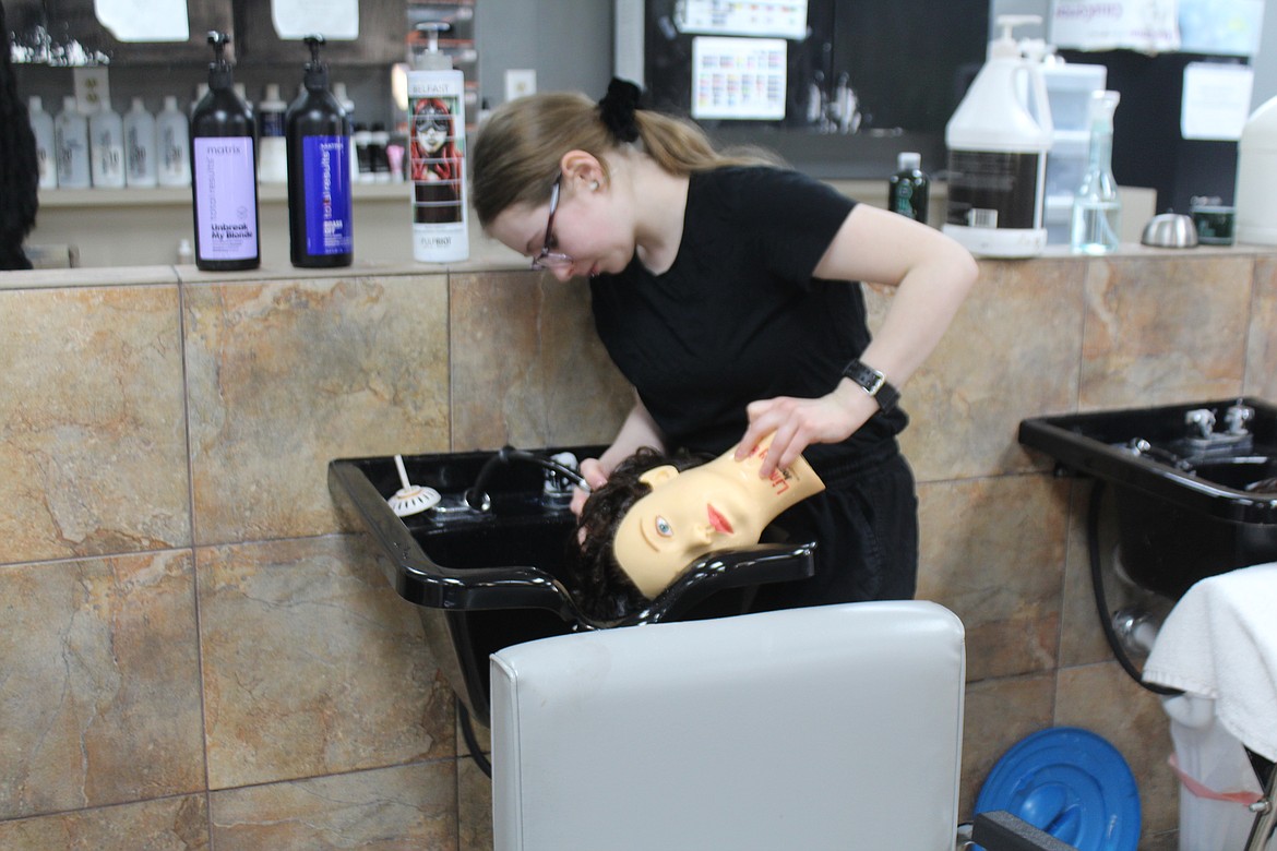 Lindsay Hall gives her mannequin a wash. Students learn a variety of skills at Char Glo and work to ensure they can meet licensing standards.