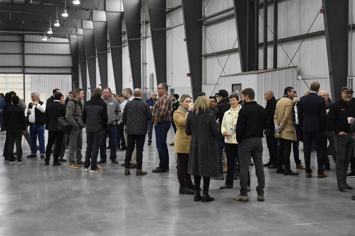 Attendees enjoy coffee and pastries while waiting for Sila’s construction ceremony to begin.