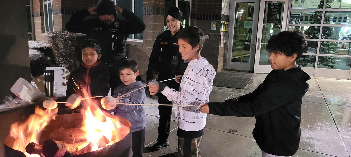 Children roast marshmallows with the help of Mattawa Police Department officers at the 2022 community Christmas celebration. The 2023 parade is Friday, with other events scheduled for Dec. 14.