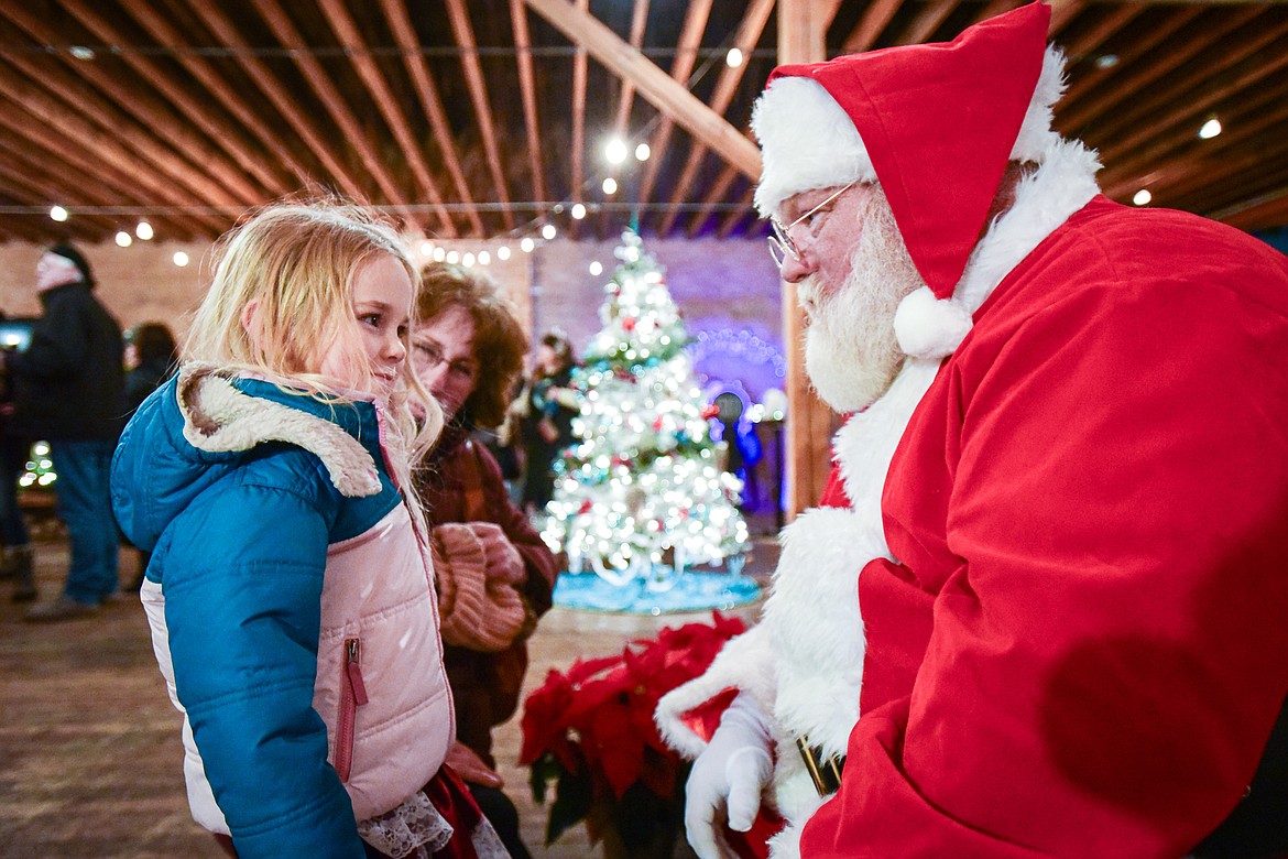 Teagan O'Connell visits with Santa Claus at Mann Mortgage's Festival of Trees, which benefited Mickayla's Miracles and Blessings Foundation, during the Downtown Kalispell Holiday Stroll and Tree Lighting on Friday, Dec. 1. (Casey Kreider/Daily Inter Lake)