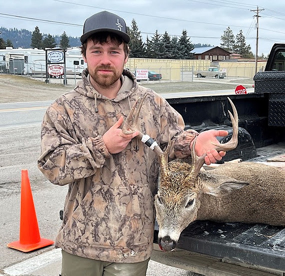 Drew Harrison with his white at a regional check station in Kalispell. (Montana Fish, Wildlife and Parks photo)
