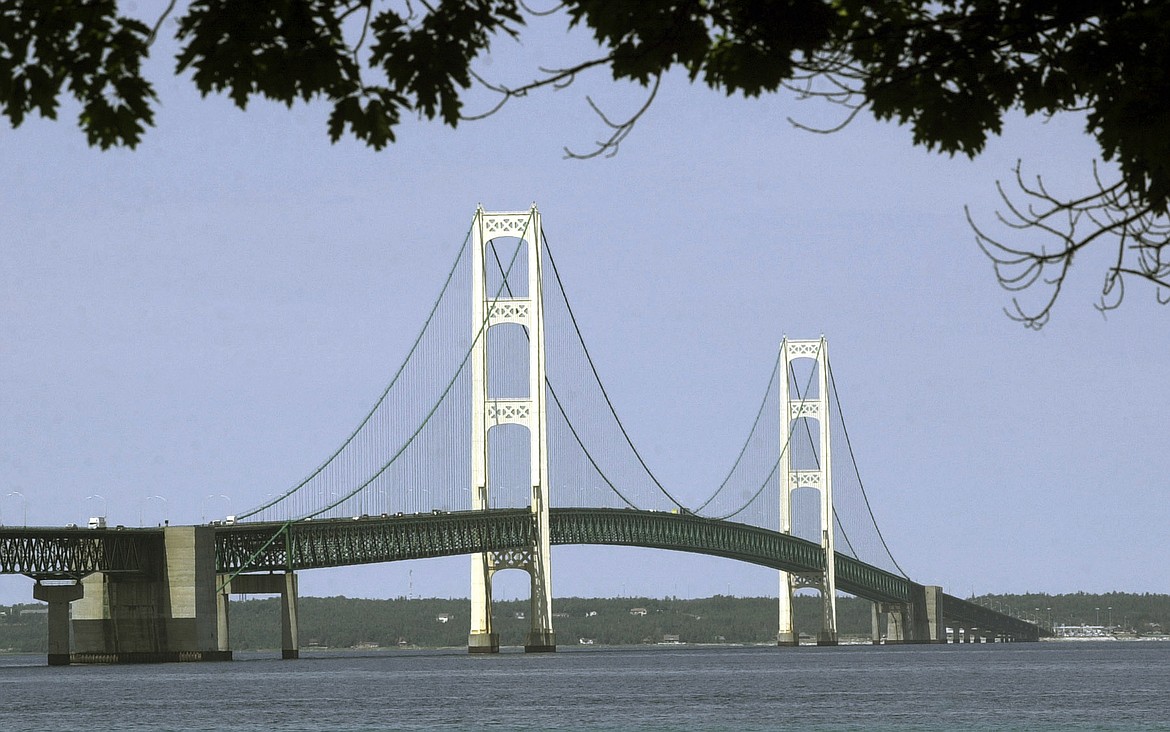 FILE - This July 19, 2002, file photo, shows the Mackinac Bridge that spans the Straits of Mackinac from Mackinaw City, Mich. Michigan regulators have approved a $500 million plan to encase a portion of an oil pipeline that runs beneath a channel connecting two Great Lakes. The state Public Service Commission on Friday, Dec. 1, 2023, approved the proposal for the tunnel through the Straits of Mackinac. (AP Photo/Carlos Osorio, File)