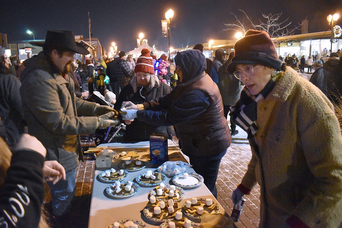 Dorian Shank, right, and Susan Barrett set out s’mores fixings for the crowd at the Moses Lake Ag Parade and Street Party Friday.