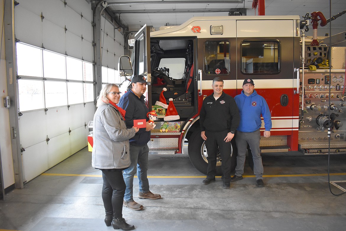 The Moses Lake Chamber of Commerce presents Firefighters for Kids with a donation from Boeing and the Association of Washington Business. From left: Chamber Director Debbie Doran-Martinez, Firefighters for Kids president Mike Miner, Moses Lake Deputy Fire Chief Chris Callahan and Boeing Fire Local I-66 President Casey Yeager.