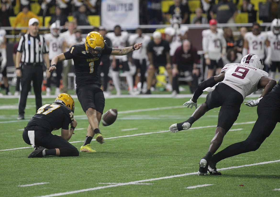 MARK NELKE/Press
With LJ Harm (47) holding, Ricardo Chavez boots a 28-yard field goal in overtime to lift Idaho past Southern Illinois 20-17 in the second round of the FCS playoffs Saturday night at the Kibbie Dome in Moscow.