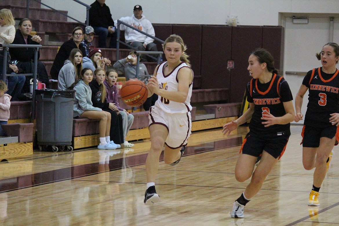 Moses Lake’s Kandall Reffett (10) pushes the ball up the floor in the Mavericks’ first game of the season Nov. 30.