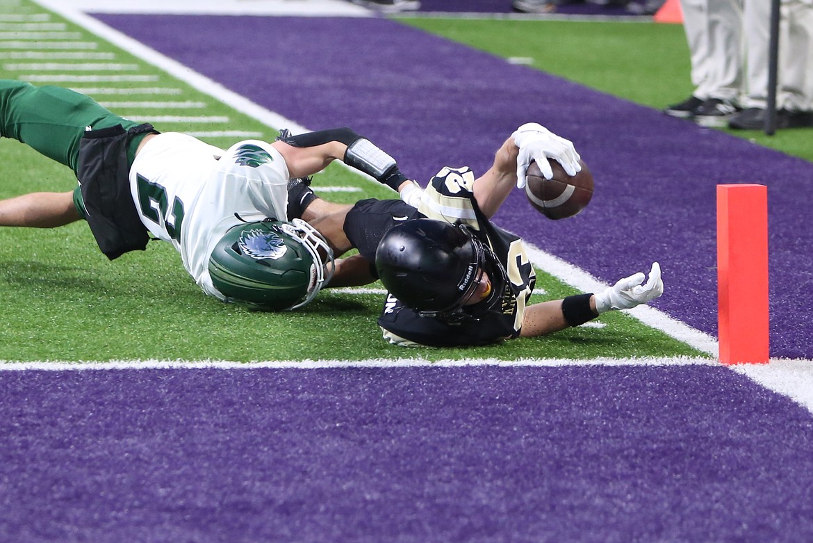 Royal sophomore Shea Stevenson, in black, reaches across the goal line for a nine-yard touchdown against Lakeside (Nine Mile Falls).