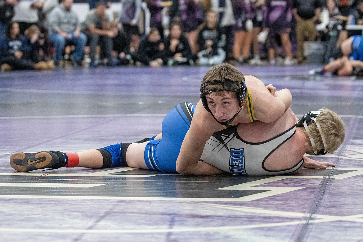 Bulldog Landree Aurand gets a hold of Blue Devil Boone Venema at the Owen Invitational wrestling tournament in Polson on Friday, Dec. 1. (Avery Howe photo)