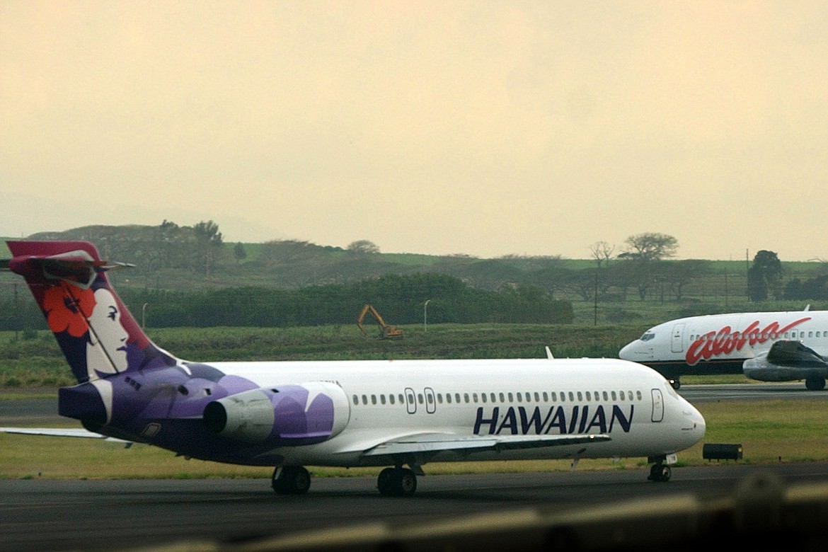 An Hawaiian Airlines plane taxis for position at Kahalui, Hawaii, on the island of Maui, March 24, 2005. Alaska Air Group said Sunday, Dec. 3, 2023, that it agreed to buy Hawaiian Airlines in a $1 billion deal. (AP Photo/Lucy Pemoni, File)