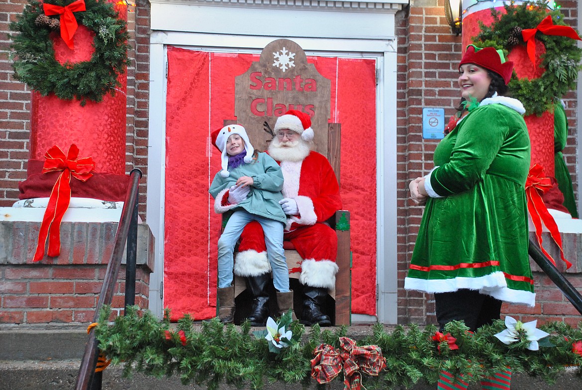 Santa and his elves received many local children's wish lists Saturday evening at the Tree Lighting Ceremony. This year Mr. Claus met with kids from the comfort and style of his brand new locally furnished wooden Santa chair. Jeff Schultz's high school shop class helped build the Christmas throne out of donated materials. (Mineral Independent/Amy Quinlivan)