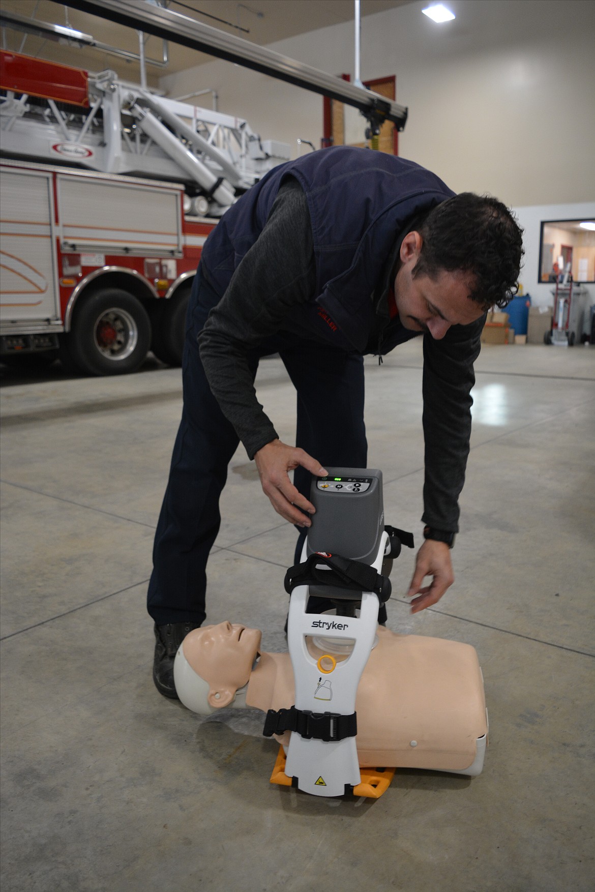 John Miller of Shoshone County Fire District No. 1 sets up the LUCAS automatic CPR device. The new machine can apply consistent CPR even in the back of a moving ambulance. Performing CPR in a moving vehicle is extremely inconsistent, and Scott Dietrich credits the tool with already improving several patient outcomes since it was added to the ambulance tools available to them.