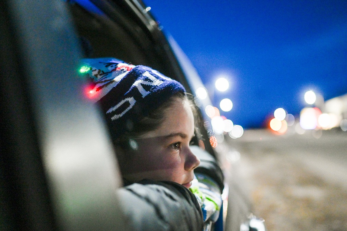 Parade watcher Zayda LaFrombois admired Mission's holiday festivities Saturday, which included a tree-lighting, Parade of Lights, and Christmas Carnival. (Christa Umphrey photo)