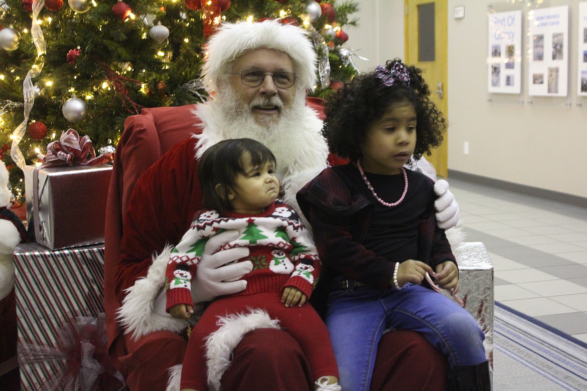 Some children at Quincy’s Christmas party liked hanging out with Santa (Kent Bacon), but some did not.