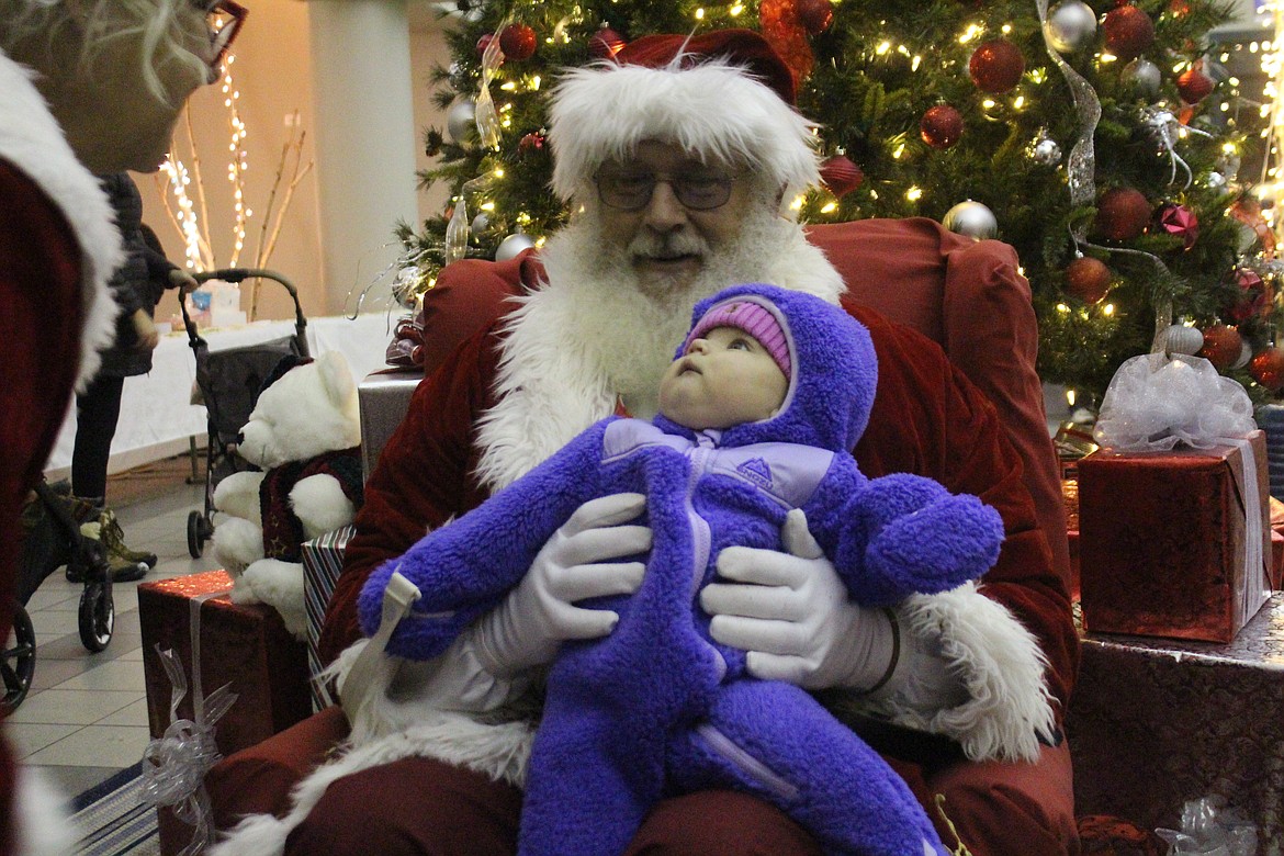 Some children who saw Santa at the Quincy Christmas party didn’t really know who that guy was.