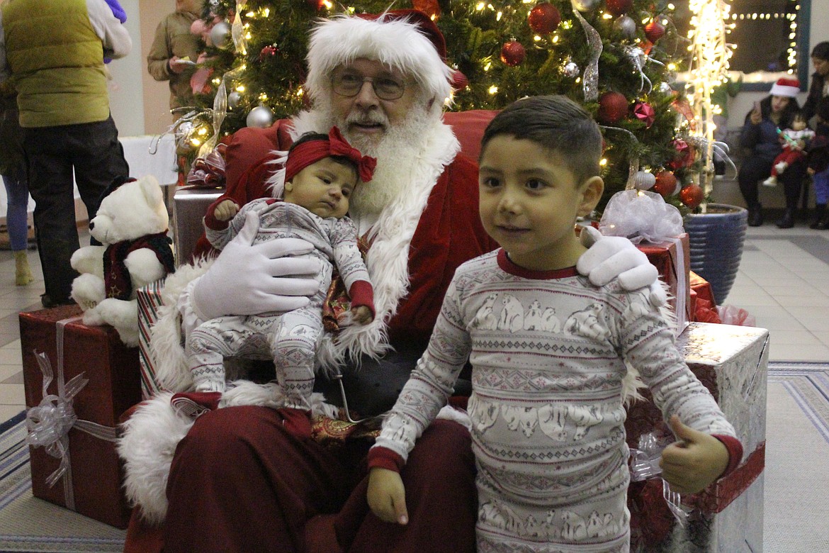 Some children wore their Christmas pajamas to get a picture with Santa.