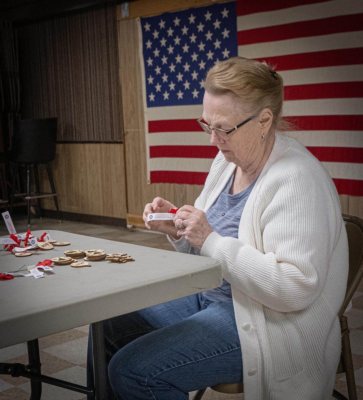 Volunteer Pat Farmer makes Christmas ornaments for each care package. (Tracy Scott/Valley Press)