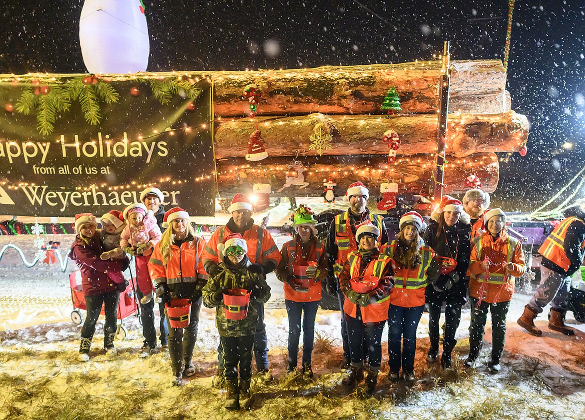 Folks from Weyerhaeuser pose in front of their float.