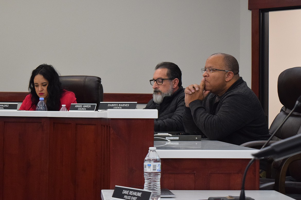 Council members Danae Valdez, Angel Garza and newly elected member Darryl Barnes listen to Othello Planning Commissioner Chris Dorow as he explains the planning commission’s consideration of certain cargo container zoning restrictions.