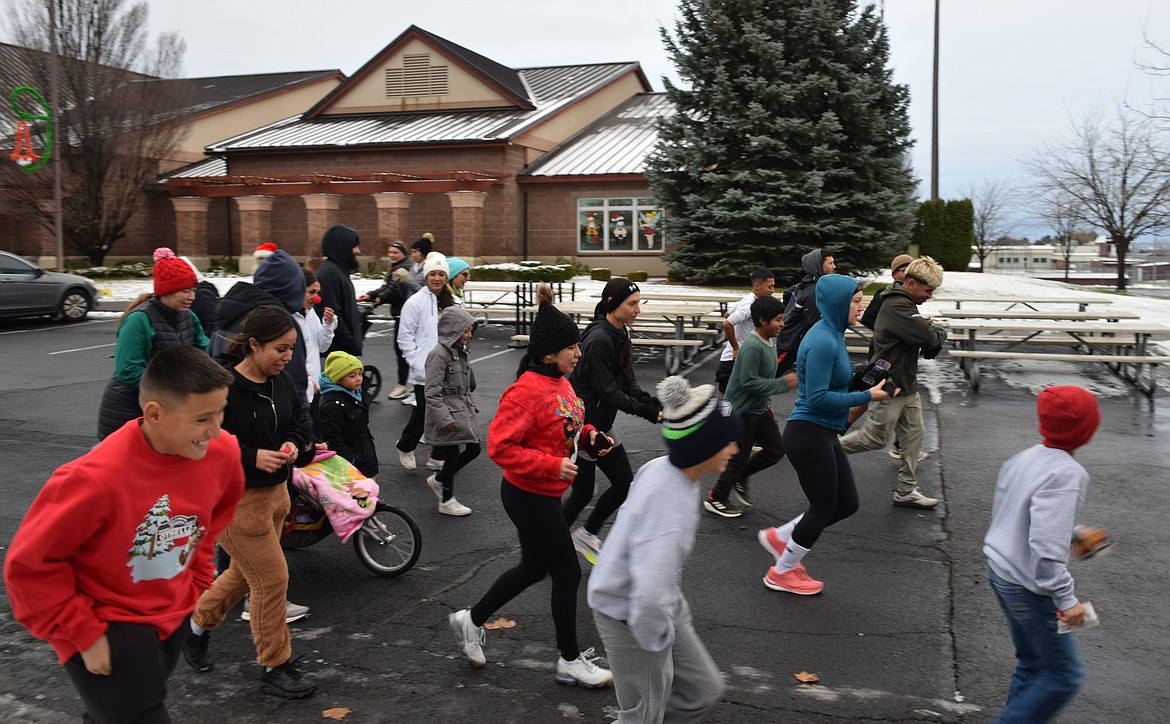 Run, Run, Rudolph 5K participants begin the race Saturday morning in front of Othello City Council. The course took them around town until looping back to City Hall.