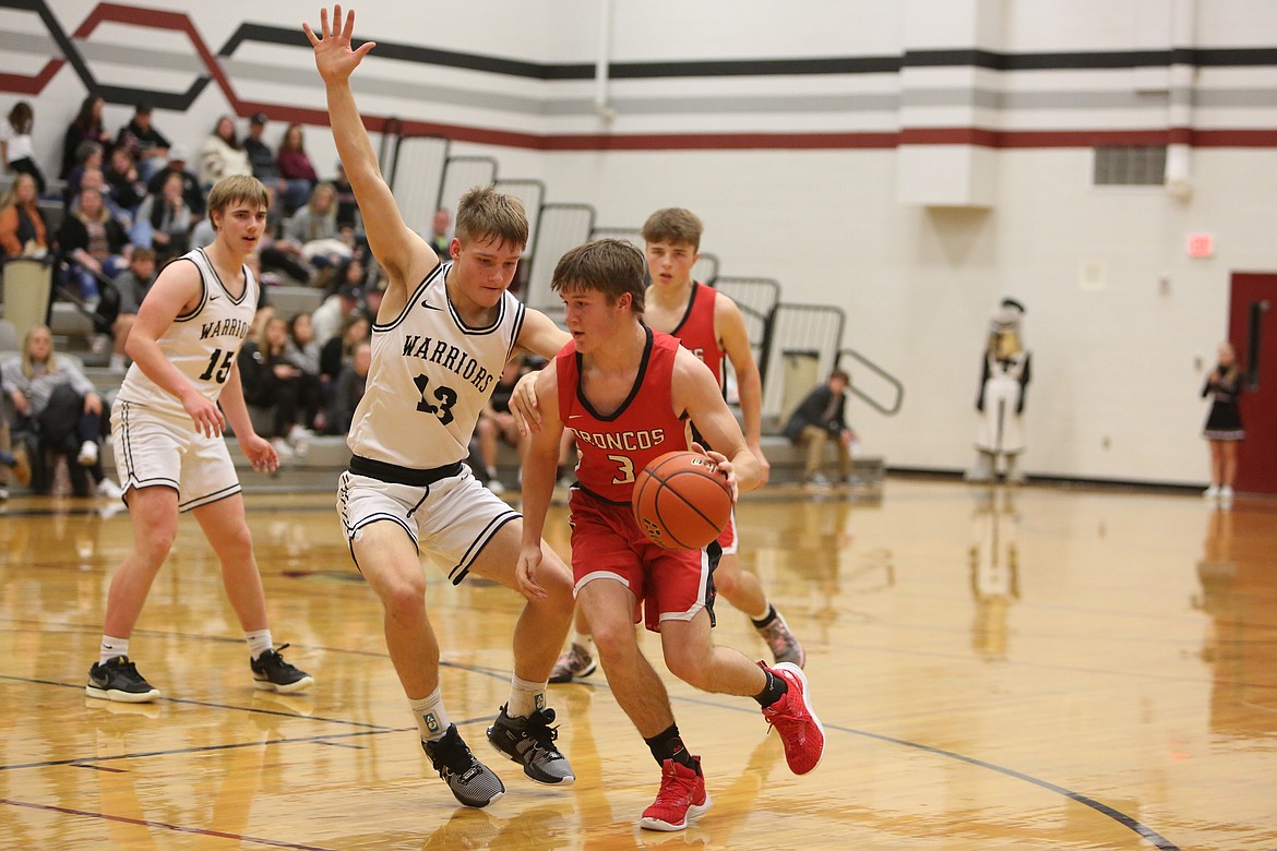 Lind-Ritzville/Sprague junior Zach Klein (3) moves up the court while being defended by Almira/Coulee-Hartline sophomore Josh Booker (13) in the fourth quarter of Saturday’s game.