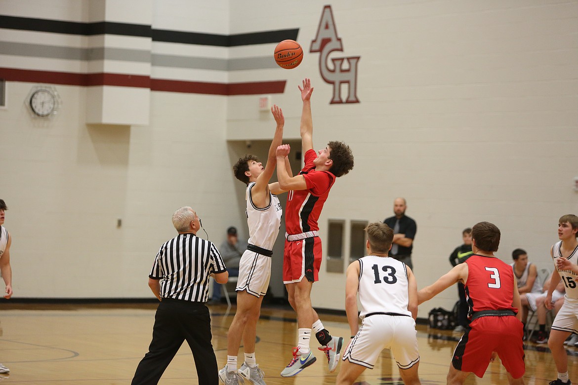 Lind-Ritzville/Sprague freshman Joey Duff, in red, and Almira/Coulee-Hartline sophomore Brady Roberts leap up for the opening tip.