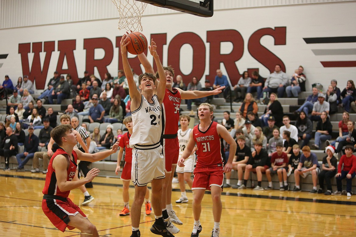 Almira/Coulee-Hartline junior Denim Kenney, in white, corrals a rebound in the second half against Lind-Ritzville/Sprague.