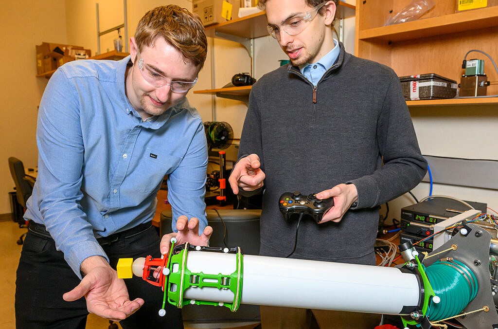 Doctoral students Justin Allen, left, and Ryan Dorosh, demonstrate a soft robot in development at WSU.