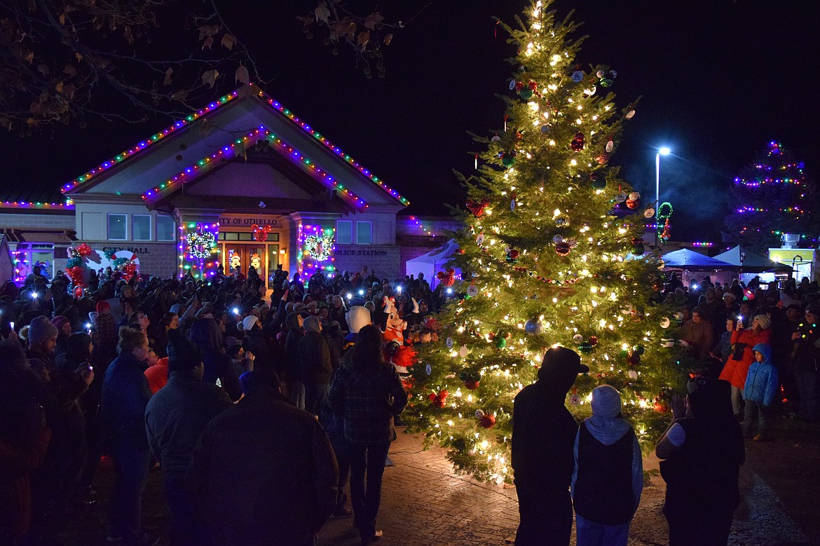 Members of the community crowd around the newly-lit Christmas tree outside Othello City Hall during the 2023 A Christmas Miracle on Main Street celebration Saturday.