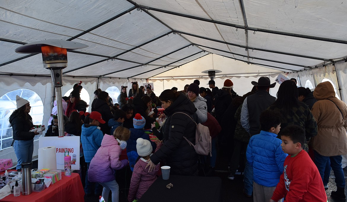 The arts and crafts tent of 2023’s A Christmas Miracle on Main Street event was packed Saturday afternoon, with a line forming outside for the children’s activities.