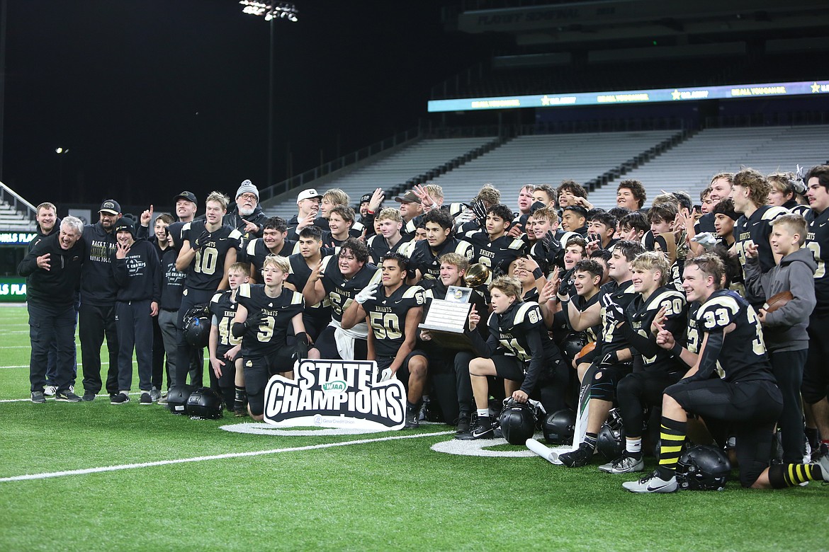 Royal players and coaches smile for photos after winning the 2023 1A state championship at Husky Stadium in Seattle, Royal’s fourth state title in a row. The Knights went 13-0 this fall, defeating Lakeside (Nine Mile Falls) 49-7 for the 1A crown.